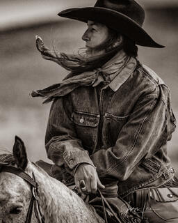 Cowgirl in the  Breeze with blowing hair.
