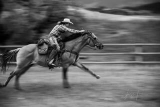 Cowgirl running on her horse