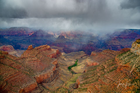 Ominous storm clouds full of rain rolling in over the Grand Canyon. 