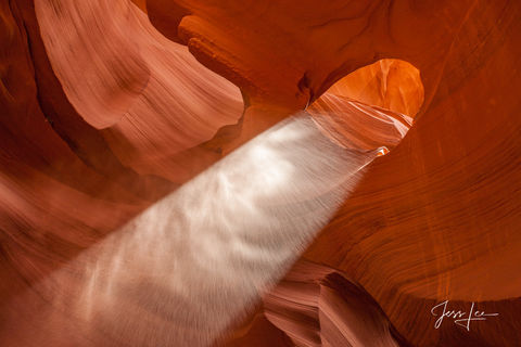 Light streaming in through a small hole in Antelope Canyon in Arizona. 