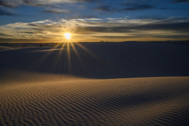 Fine art photography print of White Sands National Park, New Mexico, featuring minimalist gypsum sand dunes with delicate wind-rippled textures at sunrise.