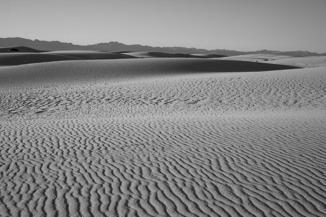 Luxury wall art of the New Mexico desert. A wide-angle landscape photograph showcasing the clean lines, rhythmic patterns, and pristine white sand of the dunes.