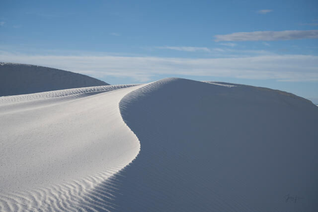 Fine art landscape photography print of expansive white gypsum sand dunes stretching to the horizon at White Sands National Park, New Mexico.