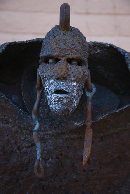 Contemporary Southwest wall art featuring a weathered metal mask study with high-definition detail.