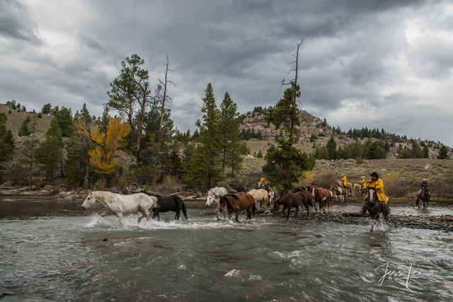 Cowboys pushing the horse herd before the storm