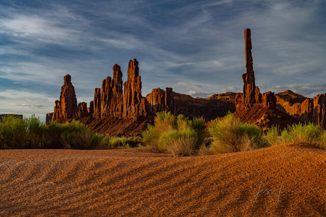 Sand Dunes and the totem pole in Monument Valley.