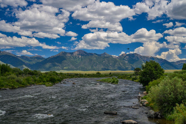 Museum-quality fine art print of fly fishers waiting for the early summer caddis hatch on the Madison River at Three Mile Bridge.