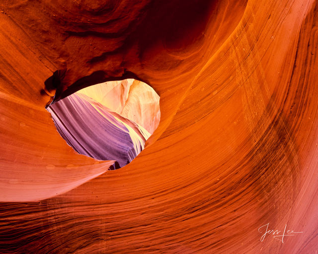 Looking through an eye in Slot Canyon's beautiful rock formations.