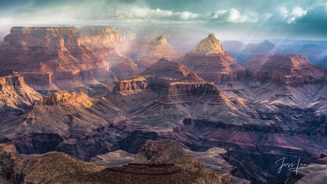 Light pouring over the Grand Canyon in Arizona, painting it all sorts of beautiful colors.