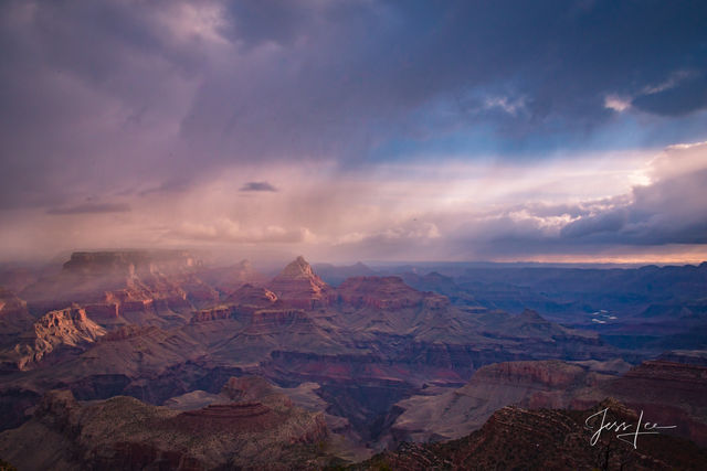 Pink and blue hues shine down onto the Grand Canyon in Arizona. 