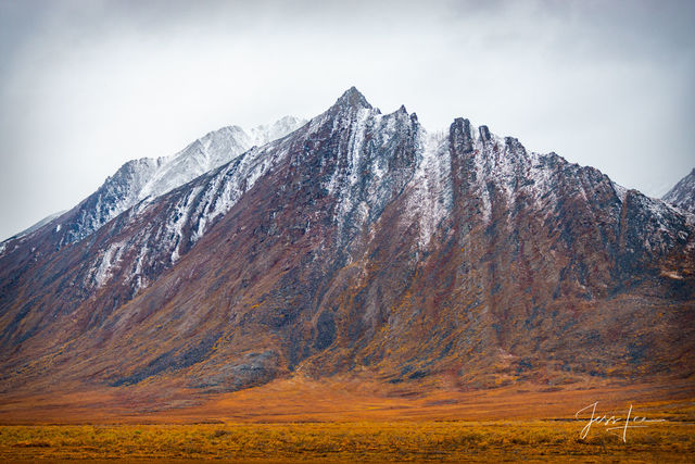 Arctic mountain covered in a thin layer of snow. 