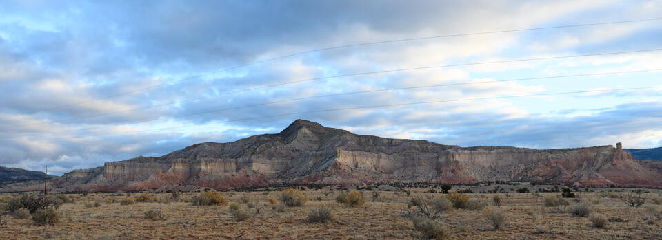 Panoramic fine art photography by Jess R. Lee of layered desert cliffs and valleys in the Rio Puerco region of New Mexico.