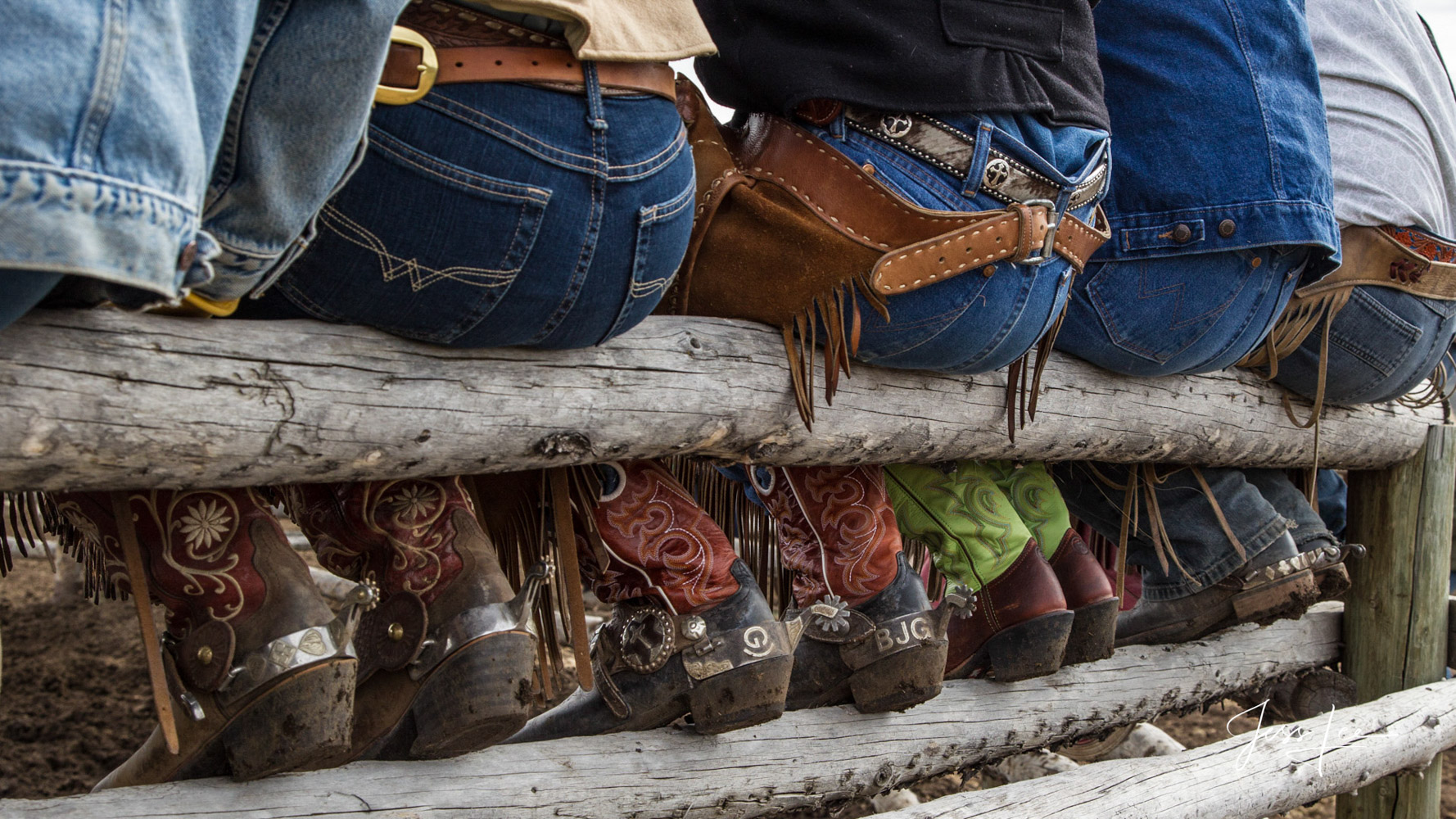 Cowboy and Cowgirls butts and boots This photograph of Cowboys and Cowgirls pictured setting on a rail fence taking a break is...