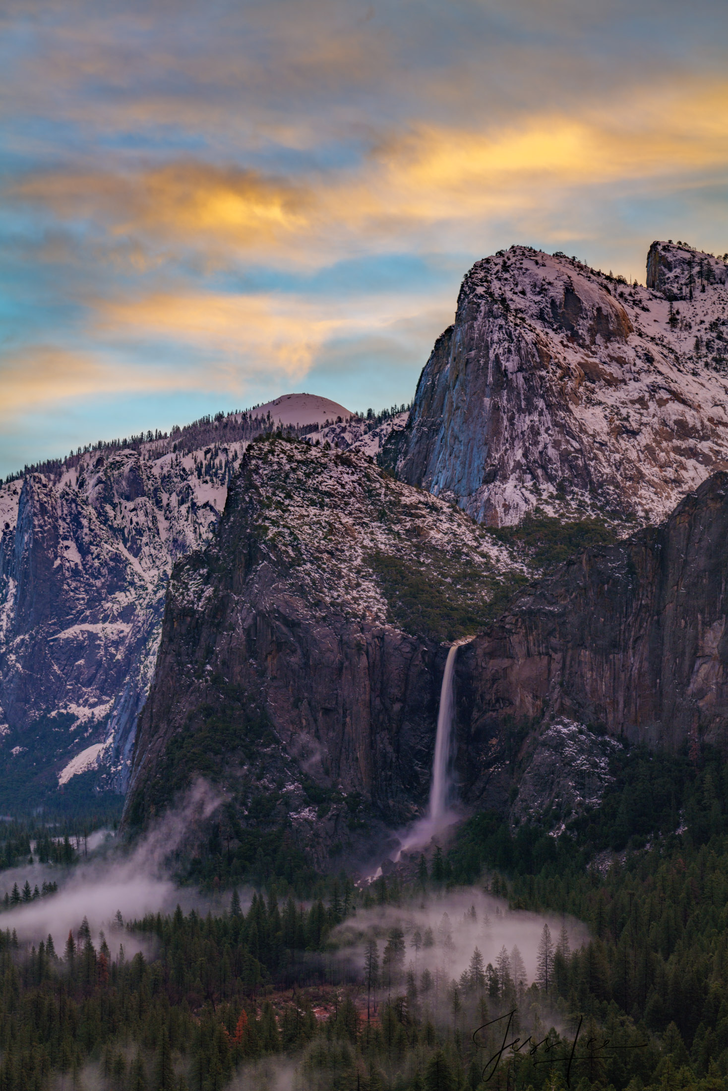 An awe-inspiring capture of a winter sunrise at Yosemite National Park, illuminating the majestic Bridalveil Falls with a radiant...