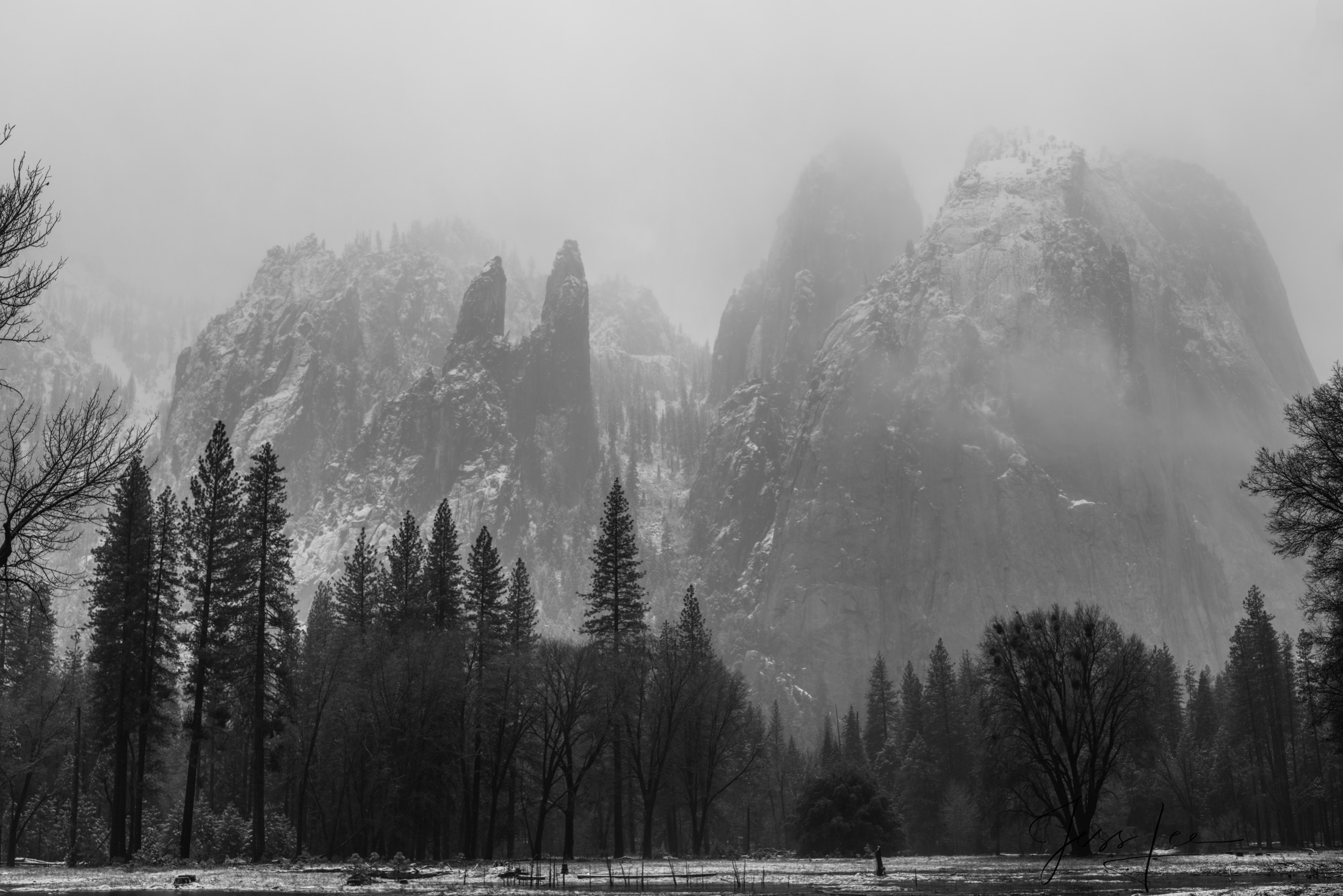 An early morning picture of Cathedral Spires in Yosemite Valley, beautifully rendered in classic black and white. Fresh snow...