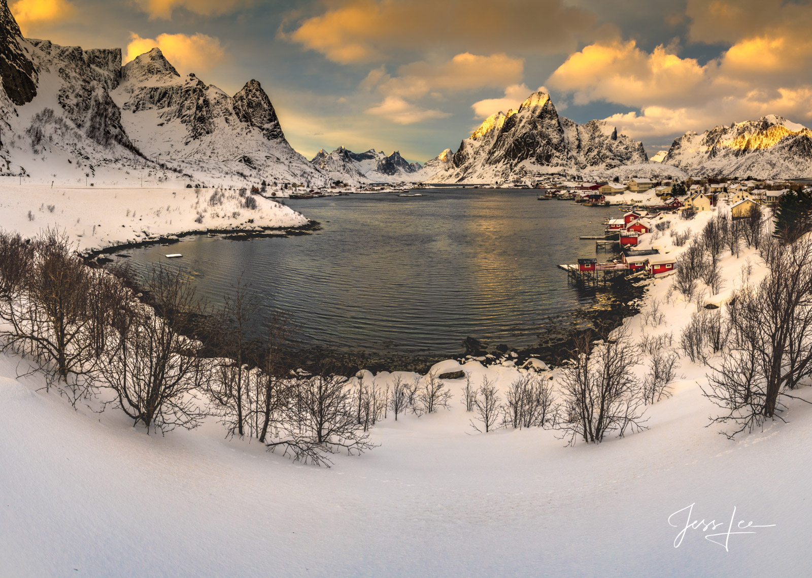 Winter Harbor Harbor in Lofoten, Norway with red buildings scattered about.