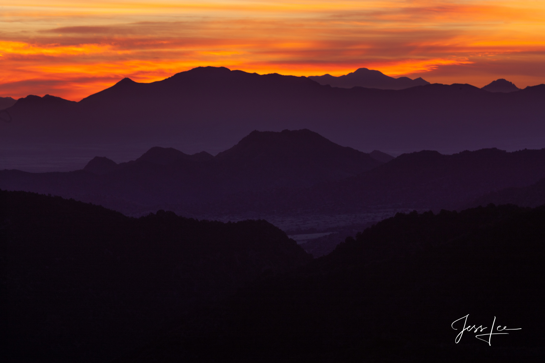 Layers of sunset colors set against mountains in the Arizona desert. 