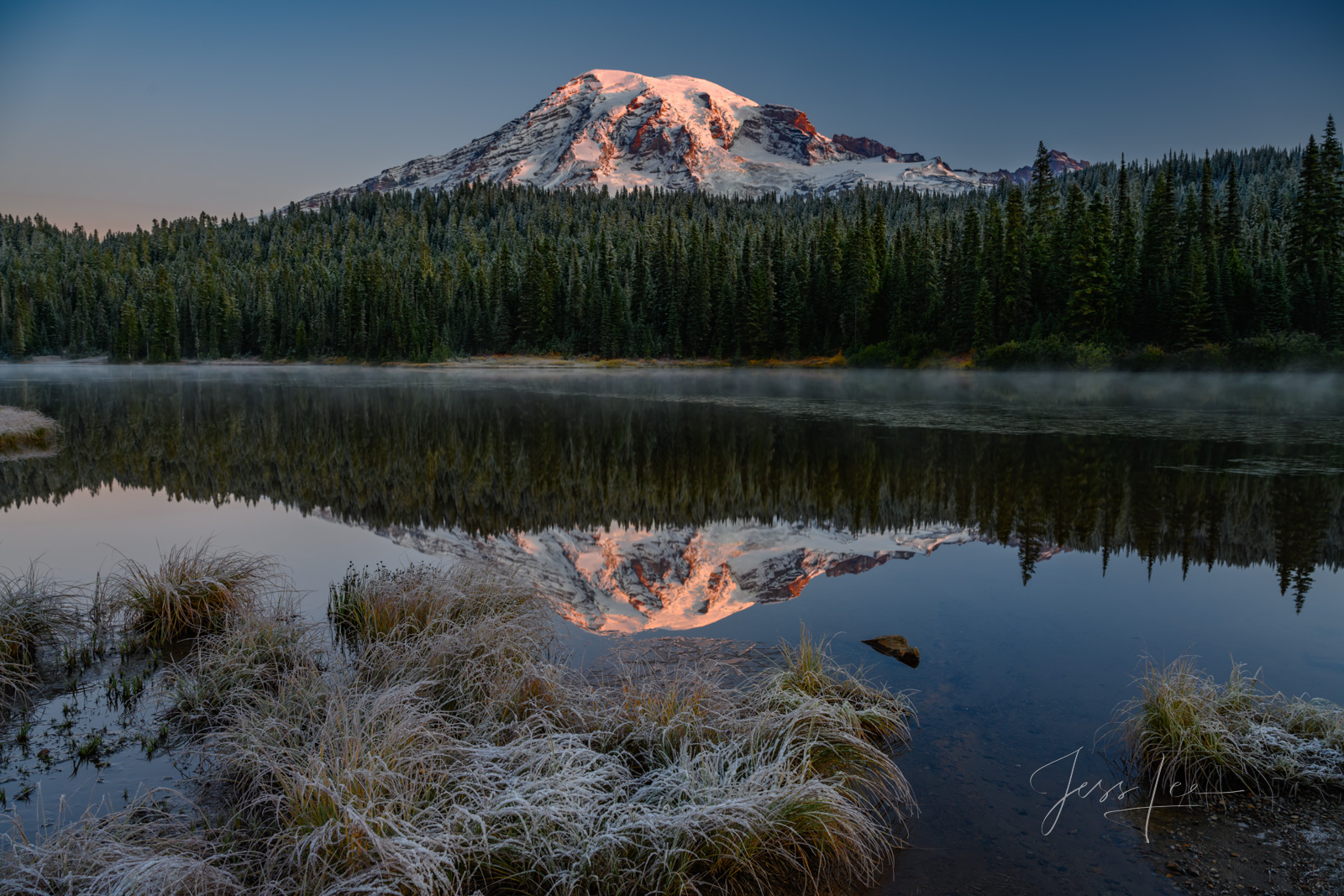 Frosty Reflection is a beautiful picture of the splendor of Mt. Rainier National Park. Flowered meadows by summer and colors...