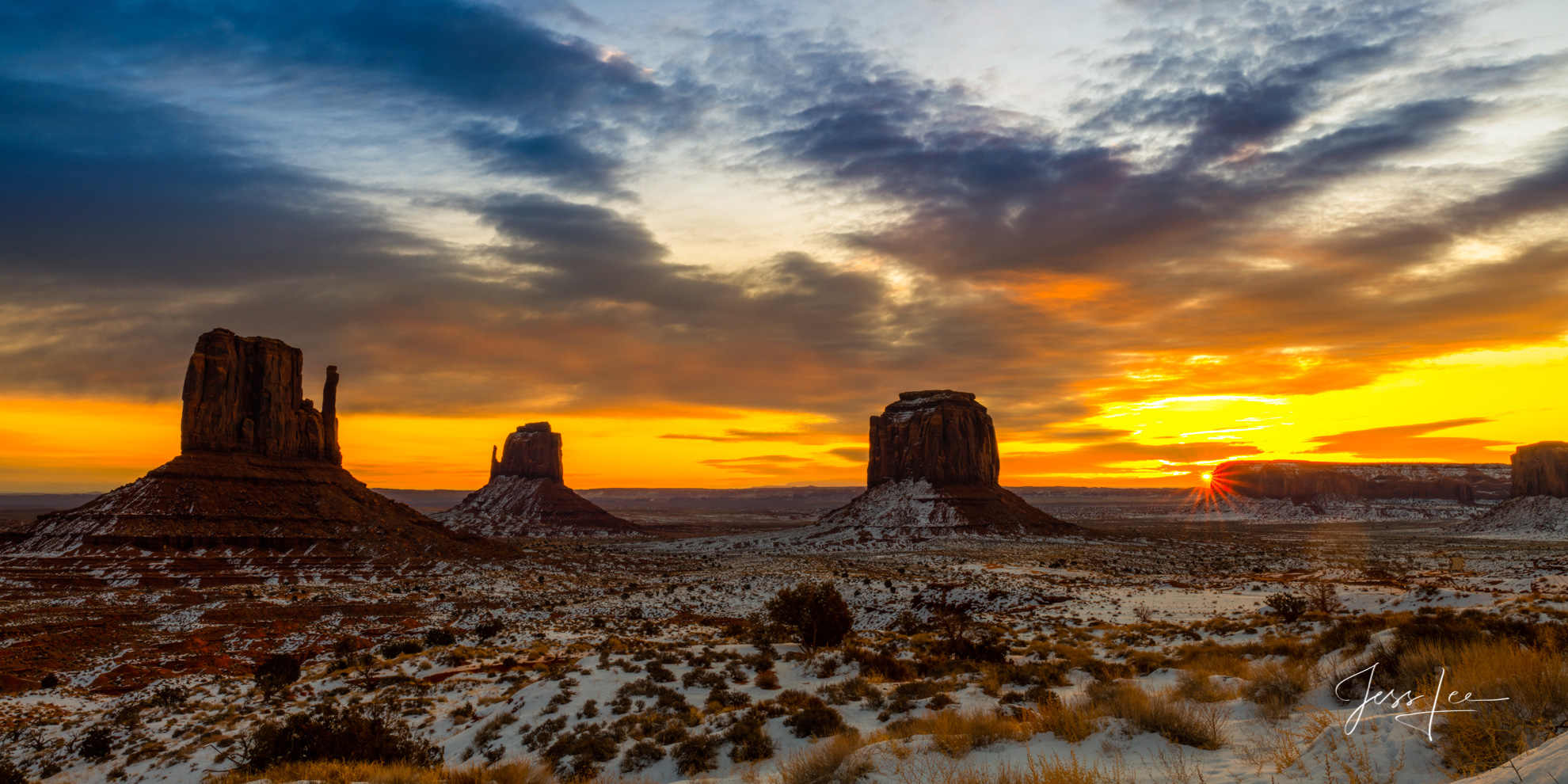Monument Valley Mittens sunburst Sunrise in Monument Valley casts beautiful colors over the vast landscape.