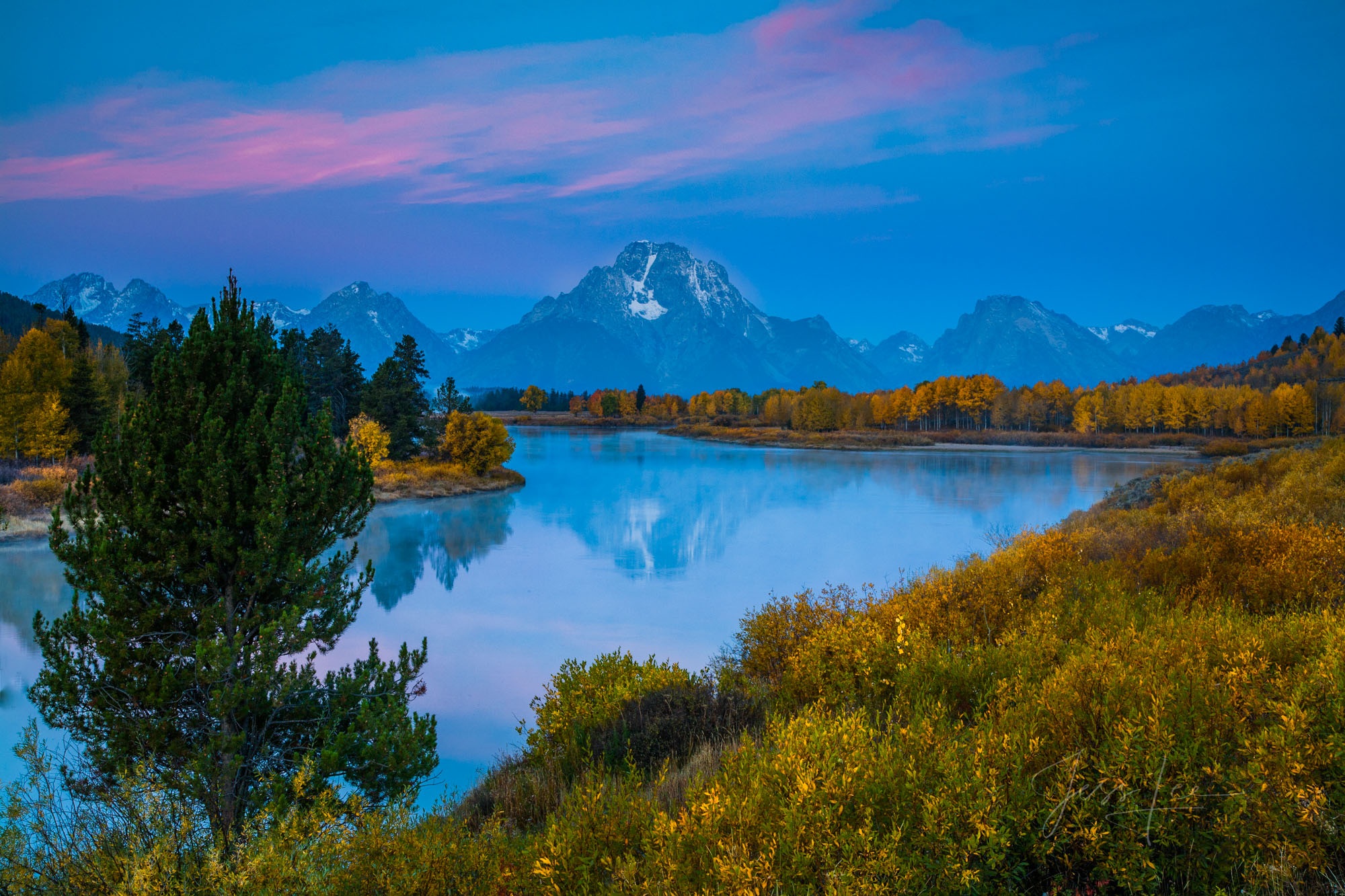 Grand Teton National Park Photo of early morning at Oxbow Bend with magenta clouds.